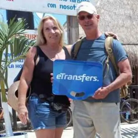 James P. holding an eTransfers sign in the Riviera Maya
